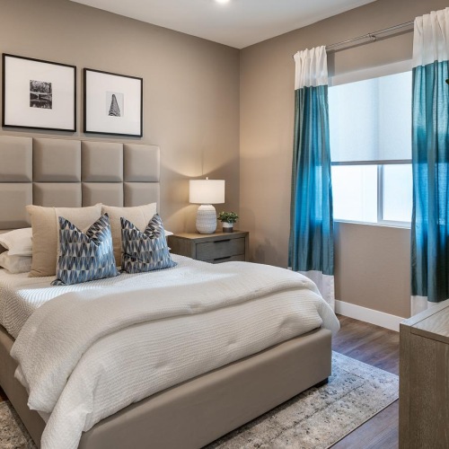 a bedroom with a bed and a fan