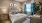 a bedroom with a bed and a fan