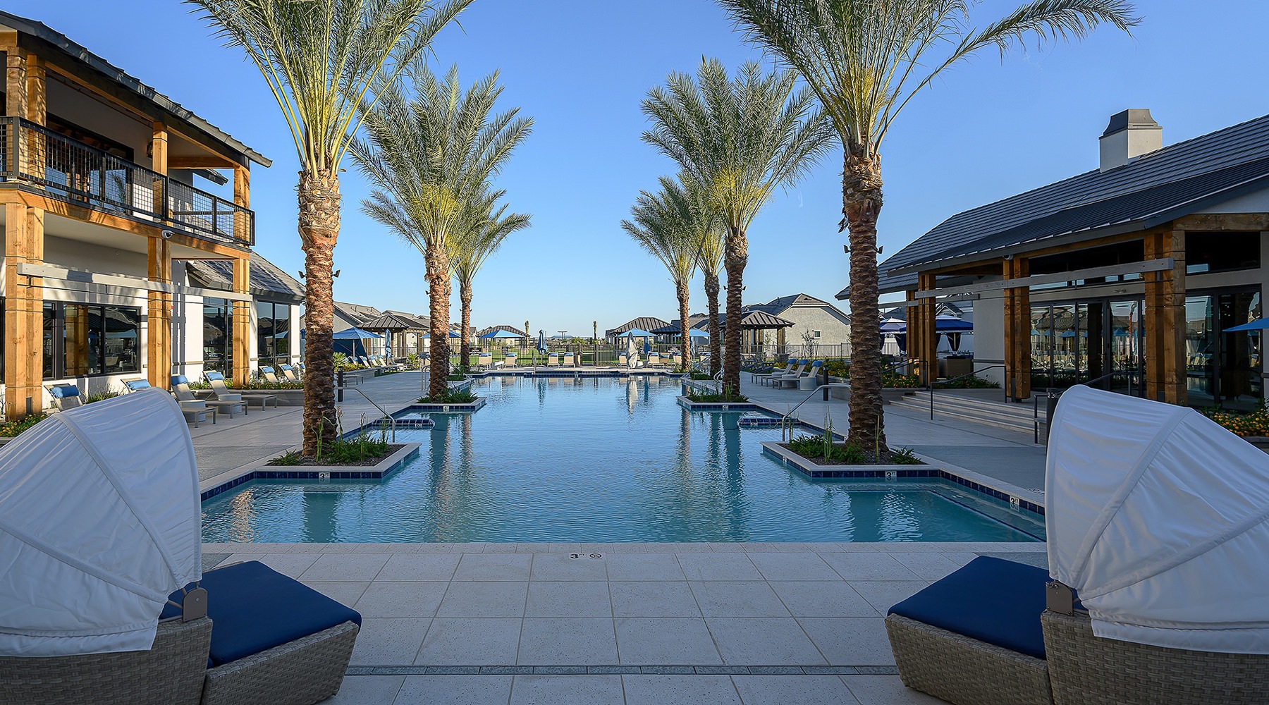 Resort-style swimming pool with lounge seating