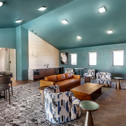 a room with a couch and chairs